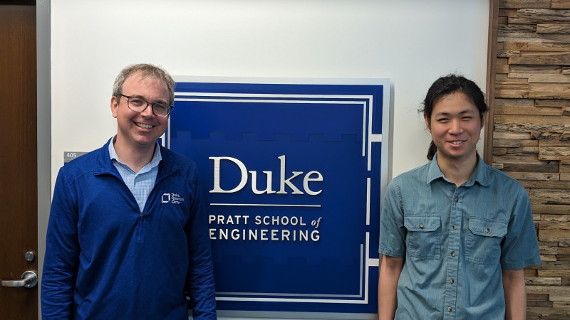 Boyan Yu and advisor Ken Brown in front of Duke Engineering sign